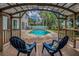 Enjoy relaxing backyard views of the pool, deck, and tropical plants from under the deck at 3002 Savannah Oaks Cir, Tarpon Springs, FL 34688