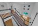 Carpeted staircase with black banisters overlooking the bright living room and pool area at 3002 Savannah Oaks Cir, Tarpon Springs, FL 34688