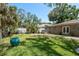 Spacious backyard with lush green grass and mature landscaping at 314 Bath St, Tarpon Springs, FL 34689