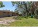 Large backyard featuring a brick barbeque and mature shade trees at 314 Bath St, Tarpon Springs, FL 34689