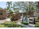 Green backyard with a brick barbeque, seating area, and mature trees at 314 Bath St, Tarpon Springs, FL 34689