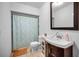 Cozy bathroom features a vanity with storage and a shower/tub combo with decorative curtain at 314 Bath St, Tarpon Springs, FL 34689