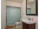 Bathroom featuring a shower with patterned curtain, sink with vanity, and neutral finishes at 314 Bath St, Tarpon Springs, FL 34689