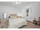 Bright bedroom features neutral decor, a comfortable bed, and a window with sheer curtains at 314 Bath St, Tarpon Springs, FL 34689
