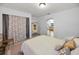 Comfortable bedroom with a patterned bedspread, decorative pillows, and an open door to the en-suite bathroom at 314 Bath St, Tarpon Springs, FL 34689