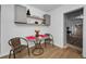 Charming dining area with a glass table, wicker chairs, and stylish decor on floating shelves at 314 Bath St, Tarpon Springs, FL 34689