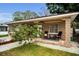 Inviting home exterior with a charming porch and comfortable seating, perfect for enjoying the outdoors at 314 Bath St, Tarpon Springs, FL 34689
