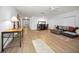 Bright and spacious living room featuring modern wood-look tile flooring and a stylish, open-concept design at 314 Bath St, Tarpon Springs, FL 34689