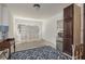 Bright living room with decorative screen, accent rug, and mini refrigerator at 314 Bath St, Tarpon Springs, FL 34689