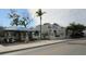Commercial view of shopping center with shops, eateries, blue roofing, and well-maintained sidewalks at 314 Bath St, Tarpon Springs, FL 34689