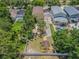 Aerial view of property showcasing backyard, tiki hut, shed, mature trees, and proximity to neighborhood pools at 316 Lafayette Blvd, Oldsmar, FL 34677