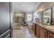 Luxurious bathroom with a glass-enclosed shower, soaking tub, and double vanity at 316 Lafayette Blvd, Oldsmar, FL 34677