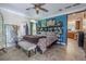 Stylish bedroom features an accent wall, unique decor, and an ensuite bathroom with a door view to the kitchen at 316 Lafayette Blvd, Oldsmar, FL 34677