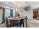 Elegant dining area with chandelier lighting, stairway, and view of the expansive open-concept living space at 316 Lafayette Blvd, Oldsmar, FL 34677