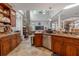 Well-appointed kitchen featuring abundant wood cabinetry, granite counters, and a stone accent wall at 316 Lafayette Blvd, Oldsmar, FL 34677