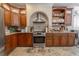 Charming kitchen featuring ample wood cabinets, stainless steel appliances, and granite counter tops at 316 Lafayette Blvd, Oldsmar, FL 34677
