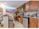 Cozy kitchenette featuring stainless steel appliances, dark wood cabinets, and a granite countertop at 316 Lafayette Blvd, Oldsmar, FL 34677