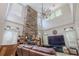 Dramatic living room featuring high ceilings, a stone fireplace, and abundant natural light from large windows at 316 Lafayette Blvd, Oldsmar, FL 34677