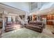 Inviting living room with high ceilings and two large leather sofas, flowing into an open-concept kitchen area at 316 Lafayette Blvd, Oldsmar, FL 34677
