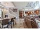 Open-concept living space featuring travertine tile flooring, staircase, dining area, kitchen, and ample natural light at 316 Lafayette Blvd, Oldsmar, FL 34677