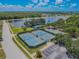 An aerial view of the tennis and basketball courts with surrounding parking and green space at 316 Lafayette Blvd, Oldsmar, FL 34677