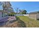 Large backyard featuring lawn, storage shed, and fenced perimeter at 3226 20Th N St, St Petersburg, FL 33713