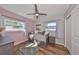 A charming bedroom features two windows, a daybed, ceiling fan, and stylish gray dresser at 3226 20Th N St, St Petersburg, FL 33713