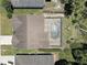 Aerial view of home with a screened pool and spa, set amidst lush landscaping at 3338 Laurelwood Ct, Tarpon Springs, FL 34688