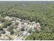 Expansive aerial view of a quiet residential neighborhood surrounded by lush greenery and mature trees at 3338 Laurelwood Ct, Tarpon Springs, FL 34688