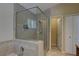 Bathroom features glass enclosed shower with tile surround, tile floors, and granite vanity at 3338 Laurelwood Ct, Tarpon Springs, FL 34688