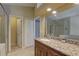 Bathroom with granite countertops, tile floors, and a glass enclosed shower at 3338 Laurelwood Ct, Tarpon Springs, FL 34688
