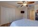 Spacious bedroom features wood floors, a ceiling fan, and a tv at 3338 Laurelwood Ct, Tarpon Springs, FL 34688