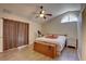 Comfortable bedroom with wood floors, a ceiling fan, and a natural light window at 3338 Laurelwood Ct, Tarpon Springs, FL 34688