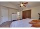 Cozy bedroom with wood floors, a ceiling fan, and a closet with room for storage at 3338 Laurelwood Ct, Tarpon Springs, FL 34688