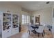 Bright dining area with white shutters, a decorative bookcase, and a modern table at 3338 Laurelwood Ct, Tarpon Springs, FL 34688