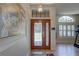 Inviting foyer showcasing a decorative glass front door and an elegant light fixture at 3338 Laurelwood Ct, Tarpon Springs, FL 34688