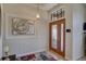 Inviting foyer showcasing a decorative glass front door, modern light fixture and artwork at 3338 Laurelwood Ct, Tarpon Springs, FL 34688