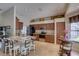 Open kitchen with wood cabinets, stainless appliances, breakfast bar, and eat-in kitchen at 3338 Laurelwood Ct, Tarpon Springs, FL 34688