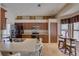 Spacious kitchen featuring wood cabinets, a breakfast bar, and stainless steel appliances at 3338 Laurelwood Ct, Tarpon Springs, FL 34688