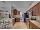 Open kitchen with wood cabinets, a breakfast bar, and stainless steel appliances at 3338 Laurelwood Ct, Tarpon Springs, FL 34688