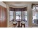 Inviting breakfast nook with bright windows overlooks the screened pool area at 3338 Laurelwood Ct, Tarpon Springs, FL 34688