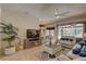 Open-concept living room with views of the kitchen, breakfast nook, and screened pool area at 3338 Laurelwood Ct, Tarpon Springs, FL 34688