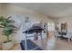 Open floor plan featuring neutral flooring, a treadmill, decorative bookcase, and a dining table at 3338 Laurelwood Ct, Tarpon Springs, FL 34688