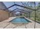 Inviting screened pool and spa, perfect for relaxation and outdoor entertaining in a private setting at 3338 Laurelwood Ct, Tarpon Springs, FL 34688
