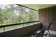 Relaxing balcony view with chairs overlooking lush green golf course and natural landscape at 36750 Us 19 N # 24-211, Palm Harbor, FL 34684