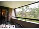 Relaxing balcony view overlooking lush greenery, with chairs and a small table at 36750 Us 19 N # 24-211, Palm Harbor, FL 34684