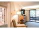 Bedroom with a sliding glass door leading to a private balcony, as well as access to the bathroom at 36750 Us 19 N # 24-211, Palm Harbor, FL 34684