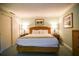 Bedroom featuring a king-size bed and two nightstands with lamps at 36750 Us 19 N # 24-211, Palm Harbor, FL 34684