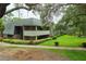 A view of an exterior condo building with green landscape at 36750 Us 19 N # 24-211, Palm Harbor, FL 34684