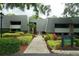 Well maintained Condo building with lush landscaping and mature trees at 36750 Us 19 N # 24-211, Palm Harbor, FL 34684